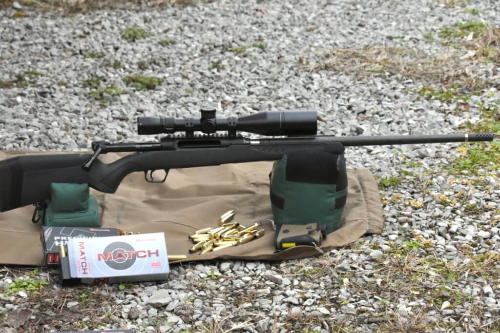 A rifle sits on shooting bags at the gun range.