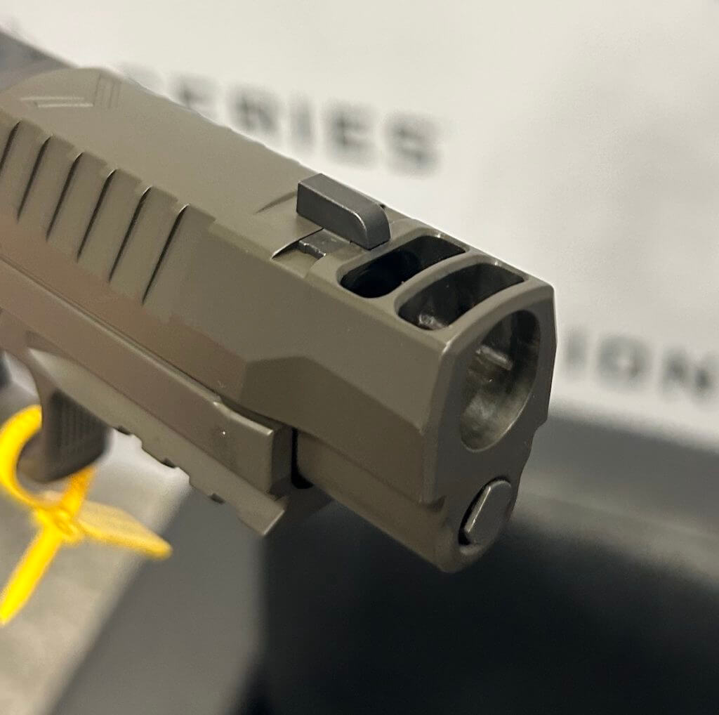 Two port slide-integrated expansion chamber for recoil mitigation.