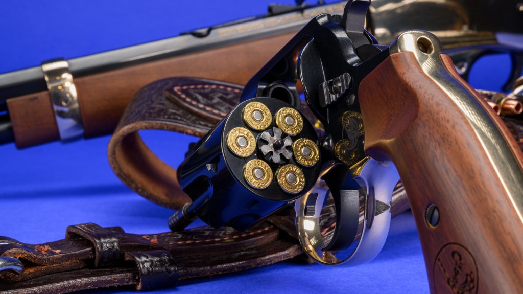 Big Boy revolver shown with cylinder out. Henry carbine seen in the background.