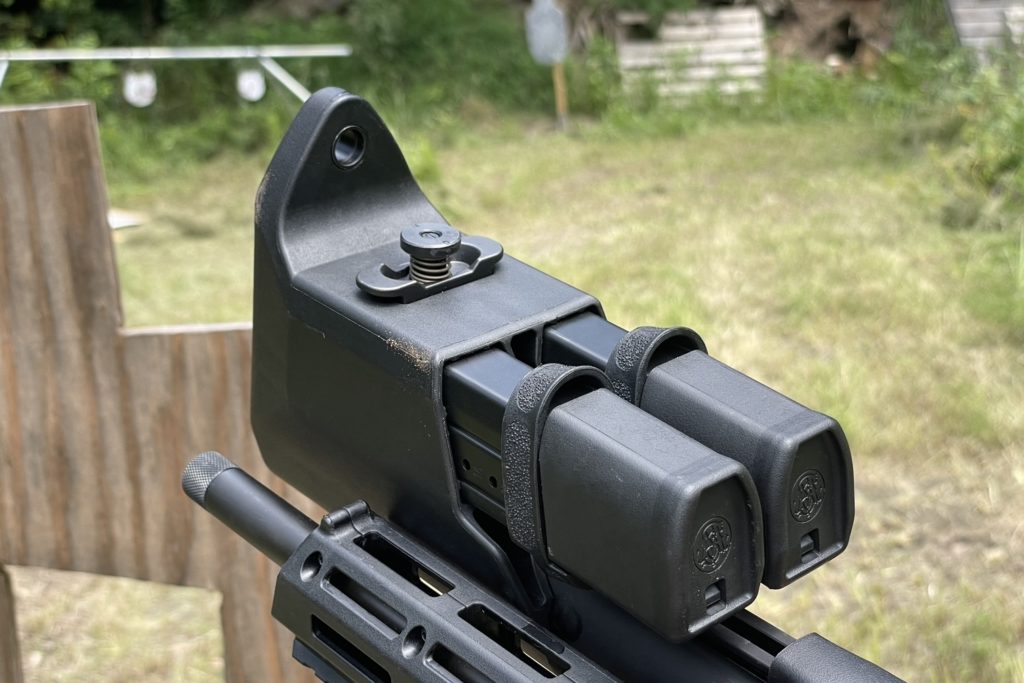 The double mag carrier integrated in the stock of the FPC with the quick release locking mechanism sticking up from the bottom